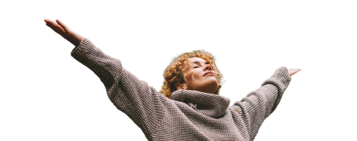 Woman stretching her arms in a forest.